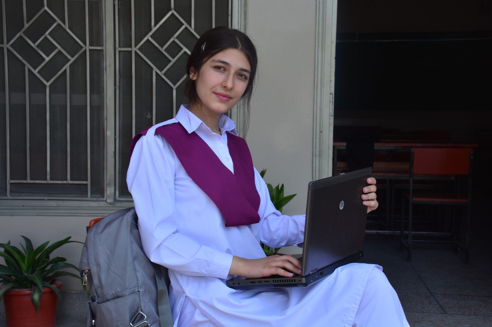 Modernage female student using laptop outdoor study