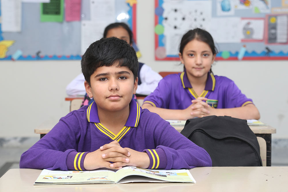 Student reading book in classroom setting