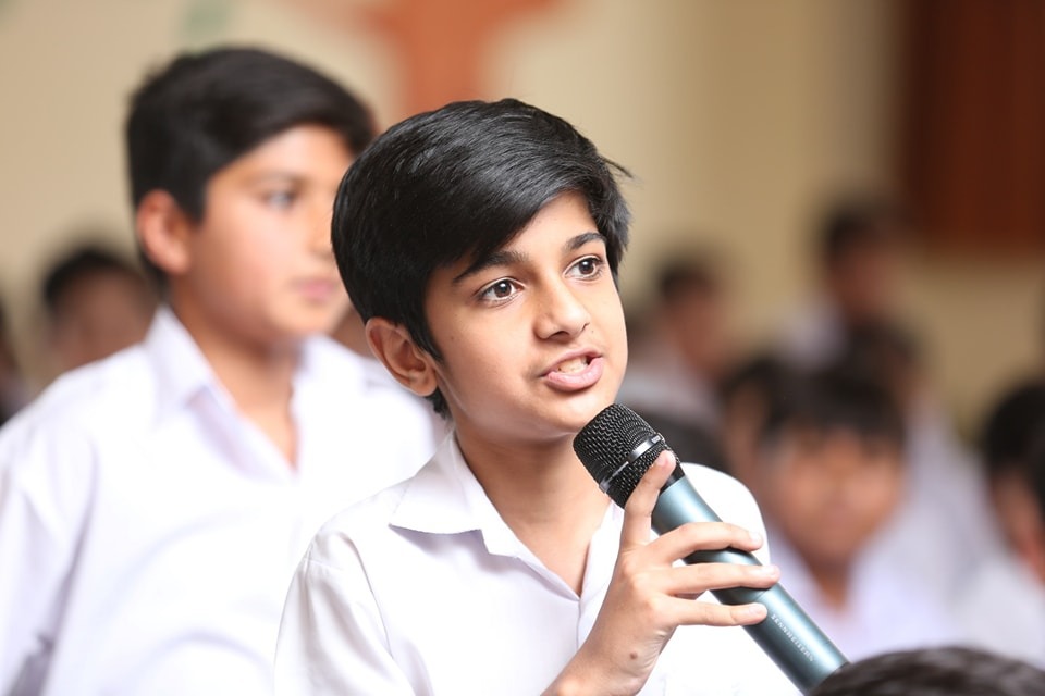 Young student drawing in colorful classroom