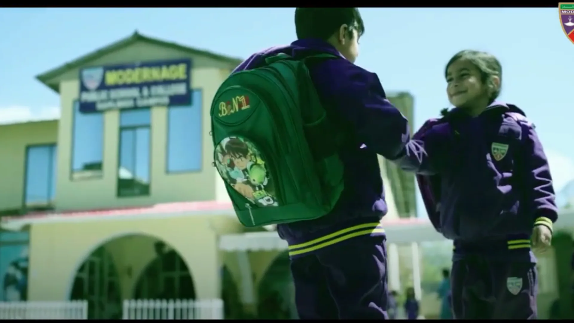 Students shaking hands outside school building